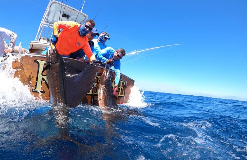 Greg on sportfishing boat with sailfish