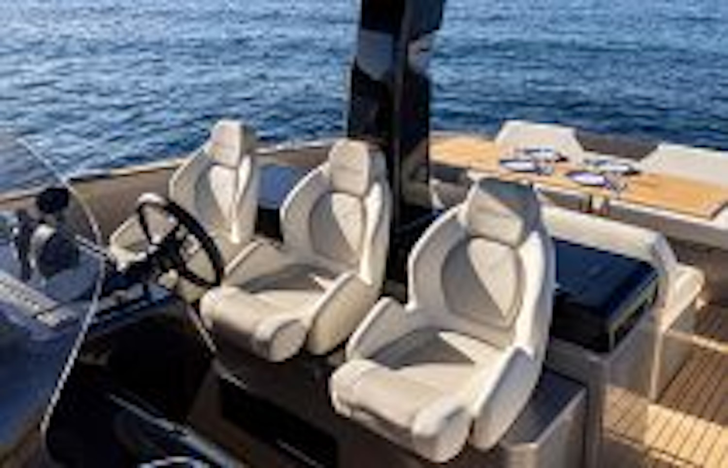 photo of three captain chairs behind helm